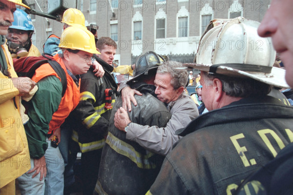 U.S. President George W. Bush embracing firefighter at World Trade Center disaster site, Financial