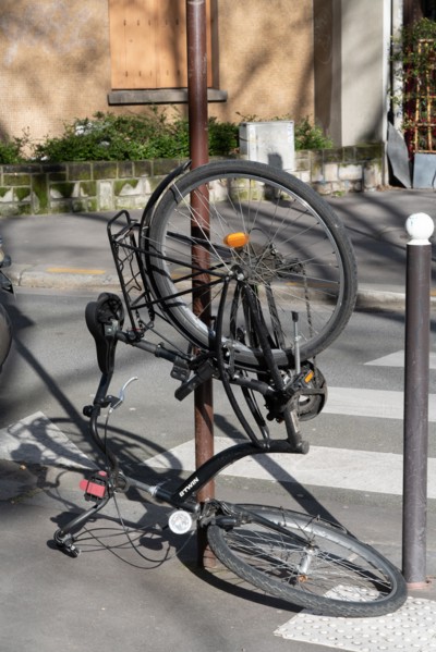 Paris, bicycle hooked at a post