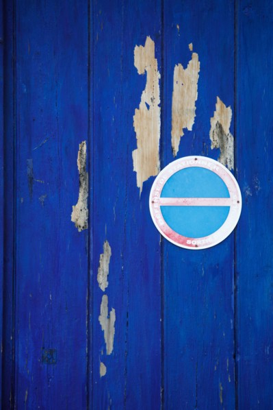 Blue door and no-parking sign