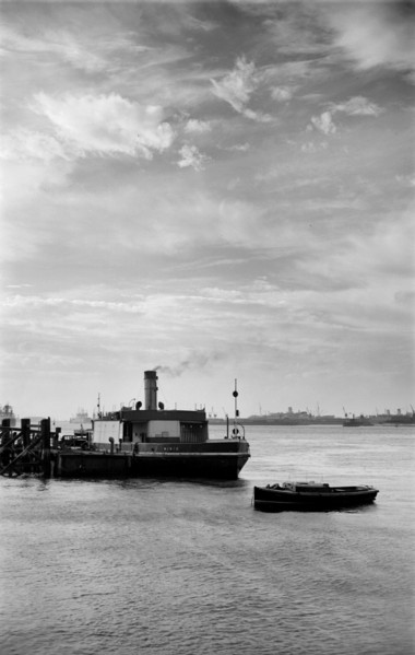 Cars embark on a ferry at Gravesend, Kent, for an evening crossing of the Thames, c1945-c1965
