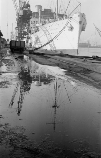 The 'Strathaird' reflected in a puddle at Tilbury Docks, Essex, c1945-c1965