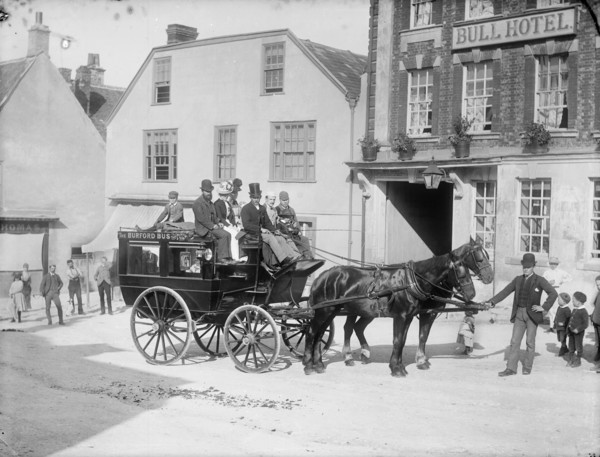 Horse drawn bus with passengers outside the Bull Hotel, Burford High Street, Oxon, c1860-c1922