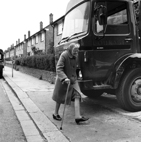 Old woman and truck on a London street, 1977. Artist: Henry Grant