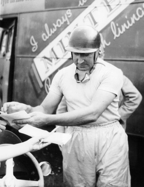 Ken Wharton signing autographs. Artist: Unknown