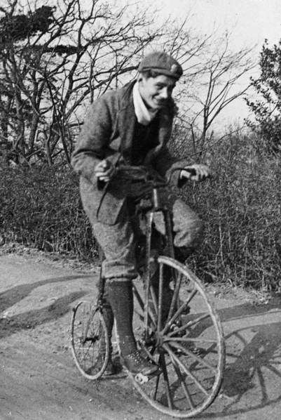 A young Lord Nuffield riding a bicycle down a country lane. Artist: Unknown