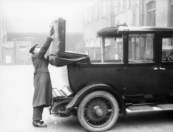Chauffeur with a partly convertible Daimler. Artist: Unknown