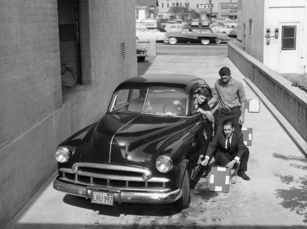 Men with a 1949 customised Chevrolet, (c1949?). Artist: Unknown