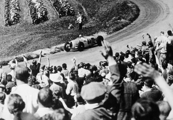 Bernd Rosemeyer acclaimed by the crowd, German Grand Prix, Nurburgring, 1936. Artist: Unknown