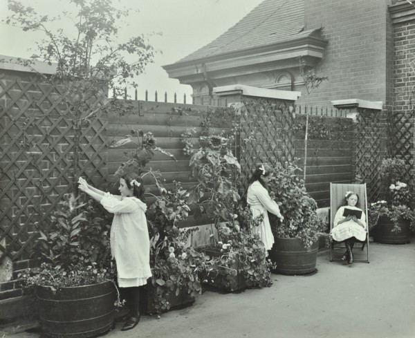 Girls gardening and reading in a roof top garden, White Lion Street School, London, 1912. Artist: Unknown.
