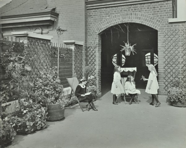 Girls relaxing in a roof top garden, White Lion Street School, London, 1912. Artist: Unknown.