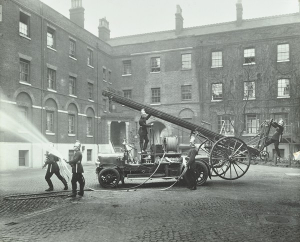 Fireman using a hose, London Fire Brigade Headquarters, London, 1910. Artist: Unknown.