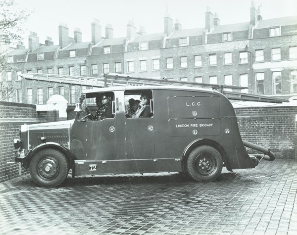Firemen inside a fire engine, Kingsland Road Fire Station, London, 1935. Artist: Unknown.