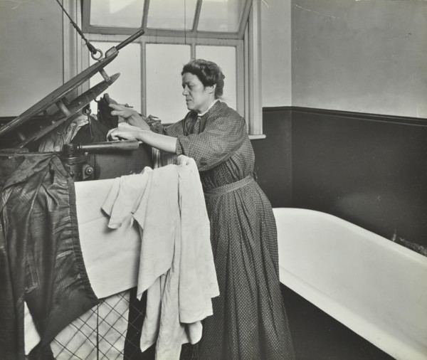 Nurse using a steriliser in the bathroom at Chaucer Cleansing Station, London, 1911. Artist: Unknown.