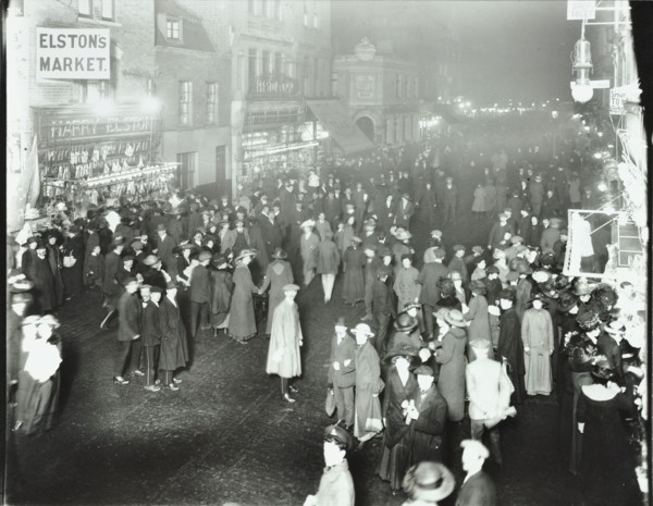 Crowds in Deptford High Street shopping after dark, London, 1913. Artist: Unknown.