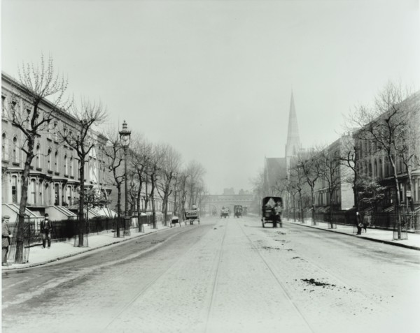 Broad tree-lined street with tramlines, Burdett Road, Stepney, London, 1912. Artist: Unknown.