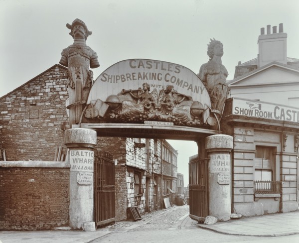 Ships' figureheads over the gate at Castle's Shipbreaking Yard, Westminster, London, 1909. Artist: Unknown.