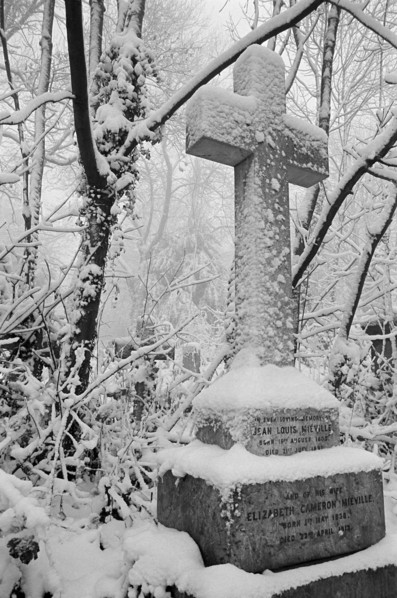 Cross on a grave in Highgate Cemetery, Hampstead, London, c1980-c1984