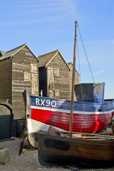 Fishing boat on the beach in front of the 'net shops', Hastings, East Sussex, c1980-c2017