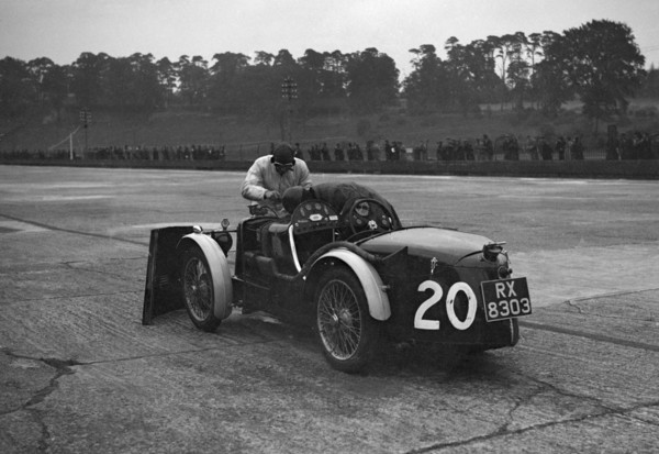 Mechanic making adjustments to a MG C type, Brooklands. Artist: Bill Brunell.