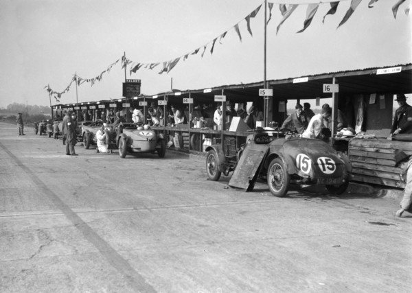 Talbot 105 and Lea-Francis cars in the pits at the JCC Double Twelve race, Brooklands, 8/9 May 1931. Artist: Bill Brunell.