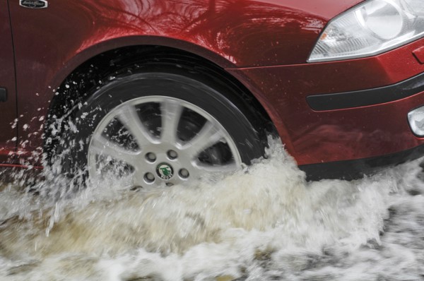 Car driving through flood. Artist: Unknown.