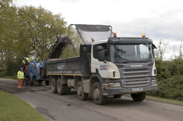 Road resurfacing work repairing potholes Artist: Unknown.