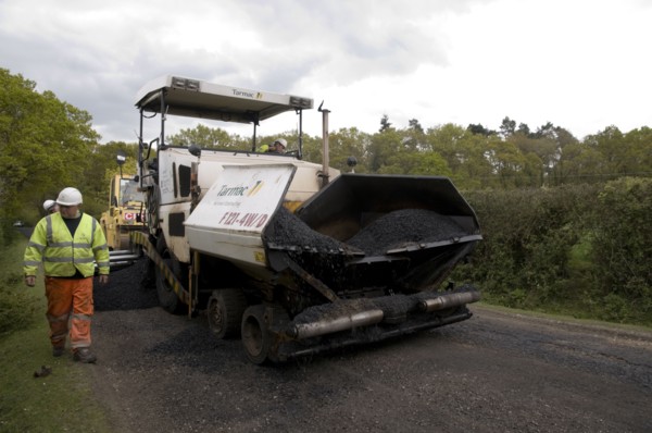 Road resurfacing work repairing potholes Artist: Unknown.