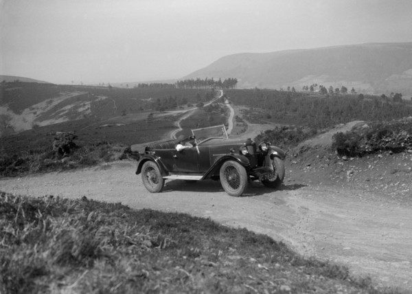 Kitty Brunell road testing a Riley 9 WD tourer, c1930. Artist: Bill Brunell.