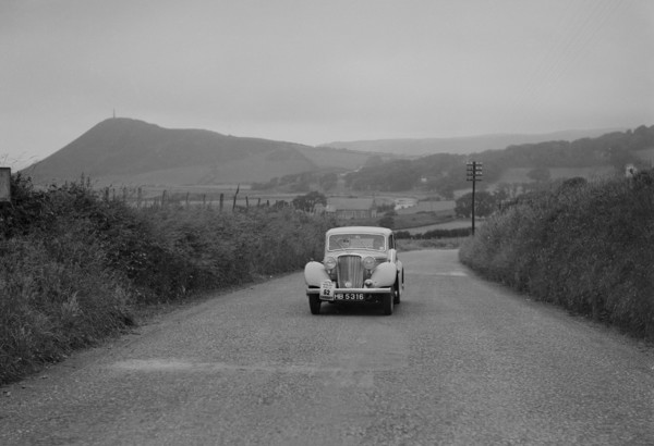 Jaguar SS saloon of N Howfield competing in the South Wales Auto Club Welsh Rally, 1937 Artist: Bill Brunell.