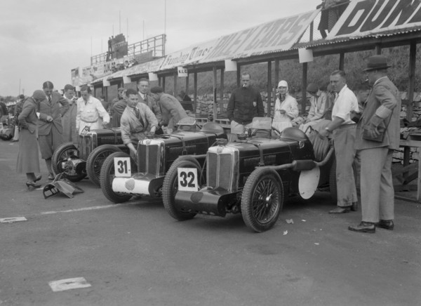 Three MG C type Midgets in the pits at the RAC TT Race, Ards Circuit, Belfast, 1932. Artist: Bill Brunell.