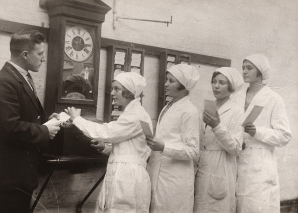 Girls queue at the Clocking-In machine, Rowntree factory, York, Yorkshire, 1933. Artist: Unknown