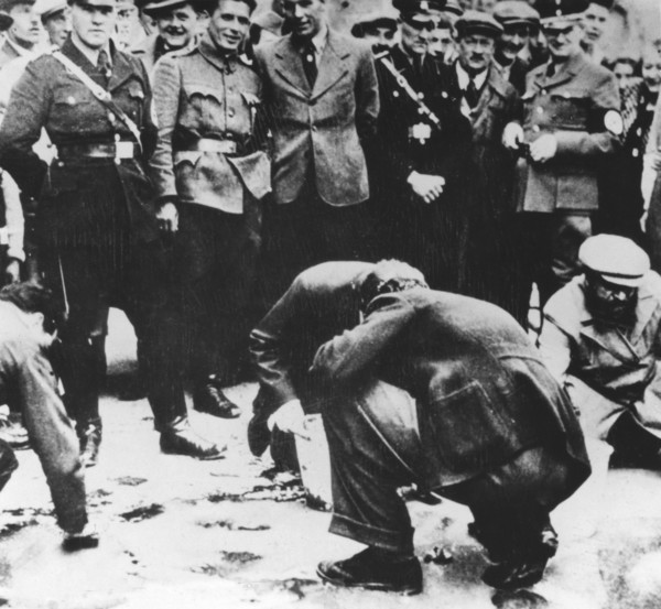 Jews are made to clean the streets of Vienna after the Anschluss, 1938. Artist: Unknown