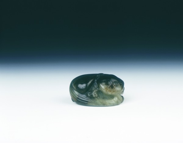Jade cat sitting curled up scratching its ear with one eye closed, Yuan dynasty, China, 1279-1368. Artist: Unknown