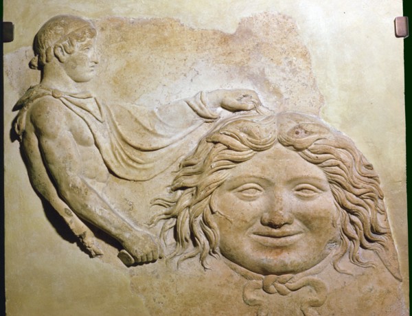 Roman fragment of a terracotta Campana relief showing head of Medusa with figure of Perseus. Artist: Unknown