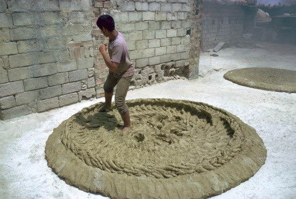 Treading clay for pottery in Tunisia. Artist: CM Dixon Artist: Unknown