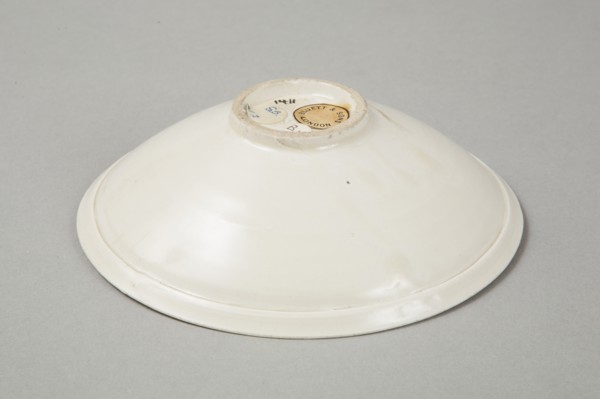 A shallow cream glazed bowl with rolled rim andraised footrim, Tang dynasty, c.800-900. Artist: Unknown.