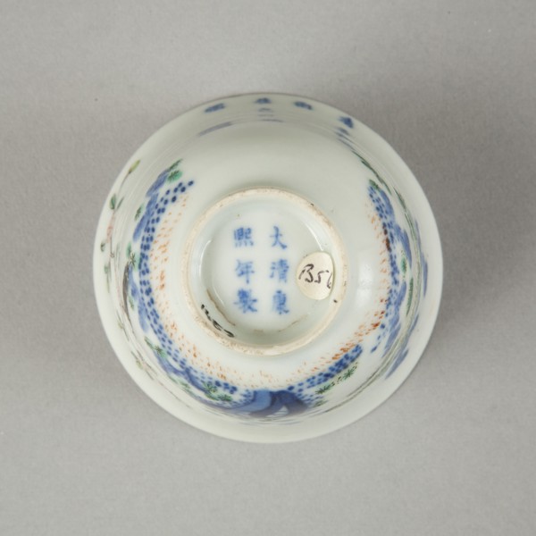 Underglaze blue month cup with polychrome enamelled decoration of a prunus tree. Artist: Unknown.