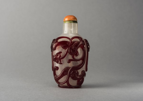 Clear glass snuff bottle with red overlay, China, Qing dynasty, 1644-1911. Creator: Unknown.