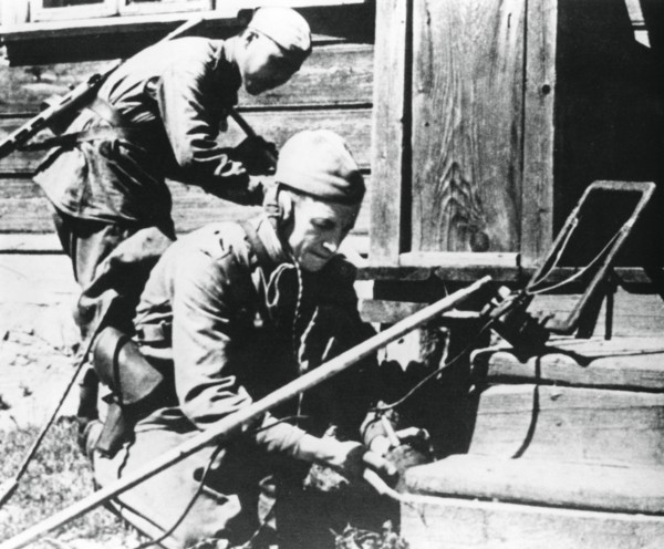 Russian soldiers with mine detectors clearing a booby-trapped house, Eastern Front, 1944. Artist: Unknown
