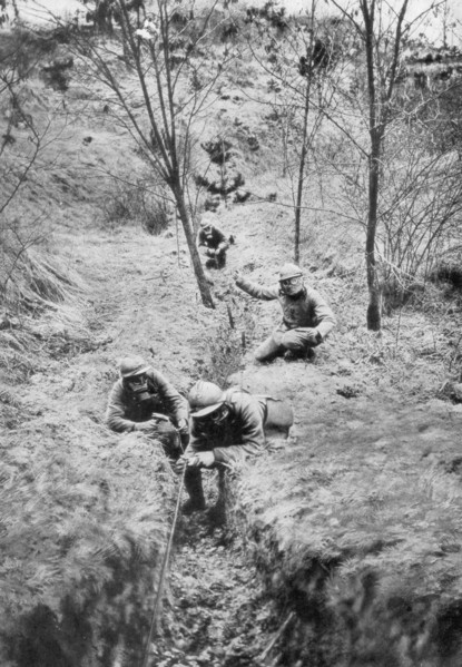 Fench sappers in gas masks re-laying telephone lines after a bombardment, 1918. Artist: Unknown