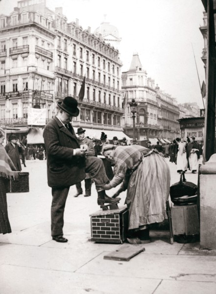 Woman polishing shoes, Brussels, 1898.Artist: James Batkin