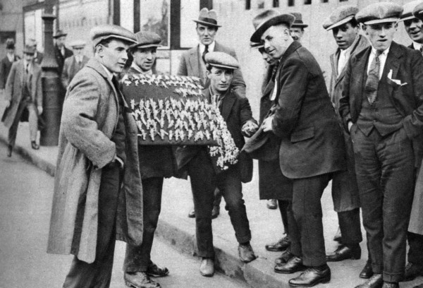 Street hawker selling football favours in King's Cross, London, 1911 (1926-1927). Artist: Unknown