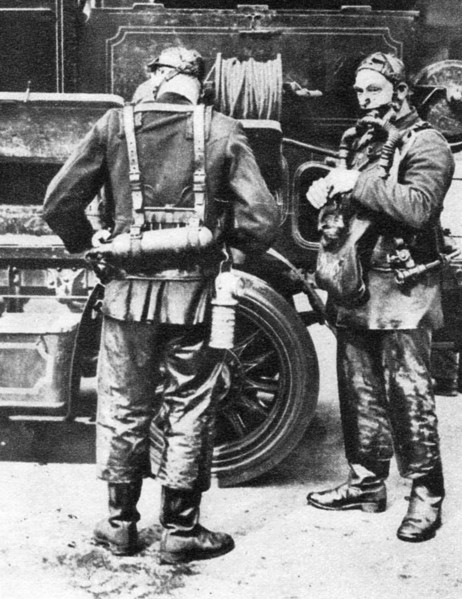 Firefighters donning smoke helmets, Farringdon Street rubber works, London, 1926-1927. Artist: Unknown