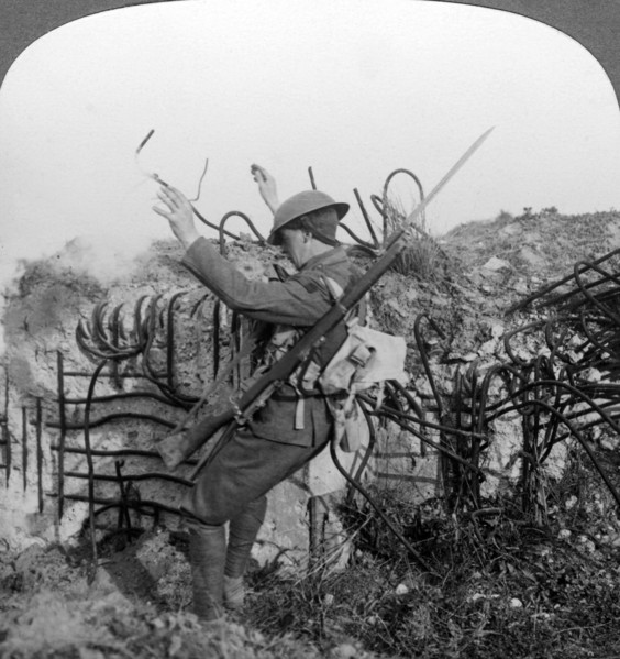 A soldier triggers a booby trap, World War I, 1914-1918.Artist: Realistic Travels Publishers