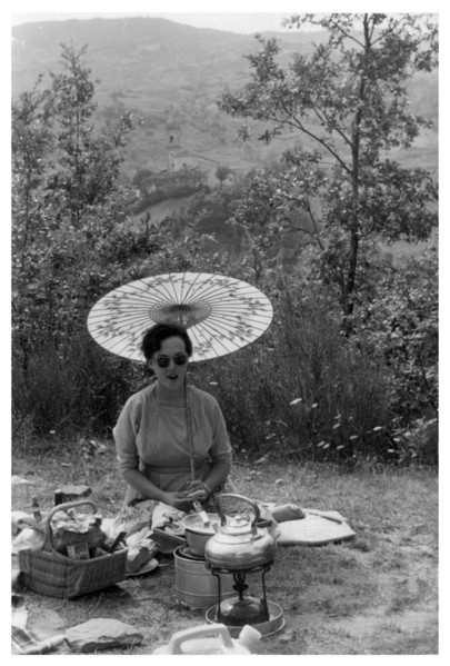 Woman under a parasol having a picnic, c1950-1969(?). Artist: Unknown