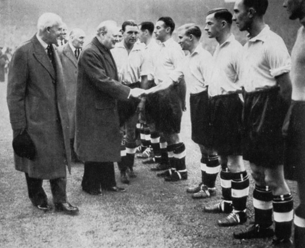 Winston Churchill greets the England football team, Wembley, London, October 1941.Artist: London News Agency
