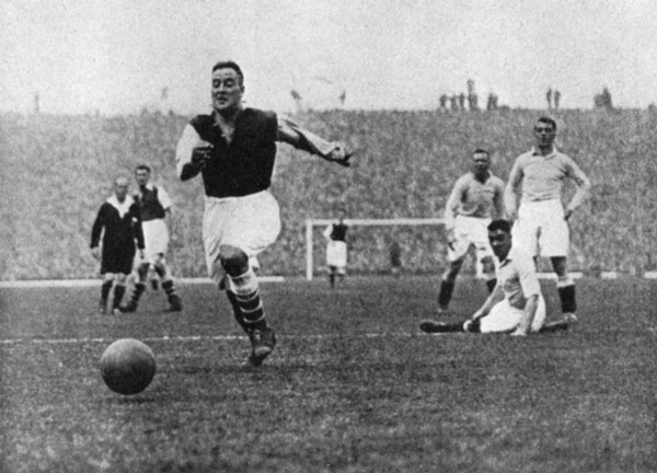 Arsenal footballer Alex James passes three Manchester City players, c1929-c1937. Artist: Graphic Photo Union