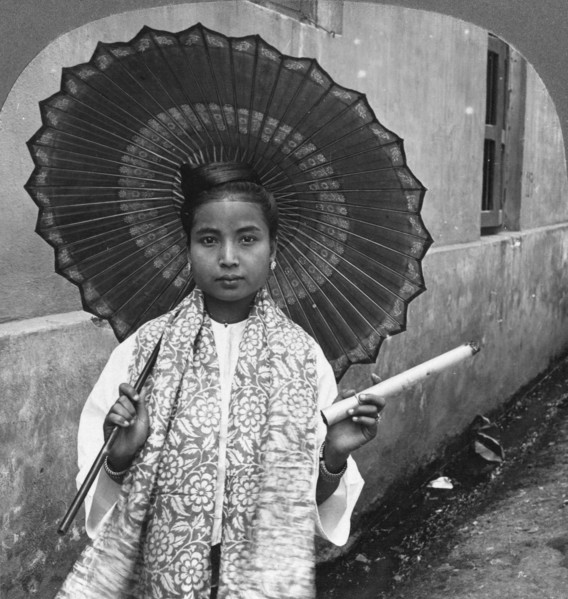 Young Burmese woman holding a huge cigar, Rangoon, Burma, 1908. Artist: Stereo Travel Co