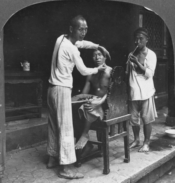 A Chinese barber at Bhamo, Burma, 1908. Artist: Stereo Travel Co