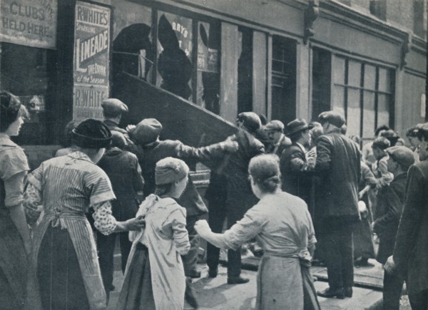 Anti-German rioting in London: A crowd breaking in the windows of a German shop', c1914. Artist: Unknown